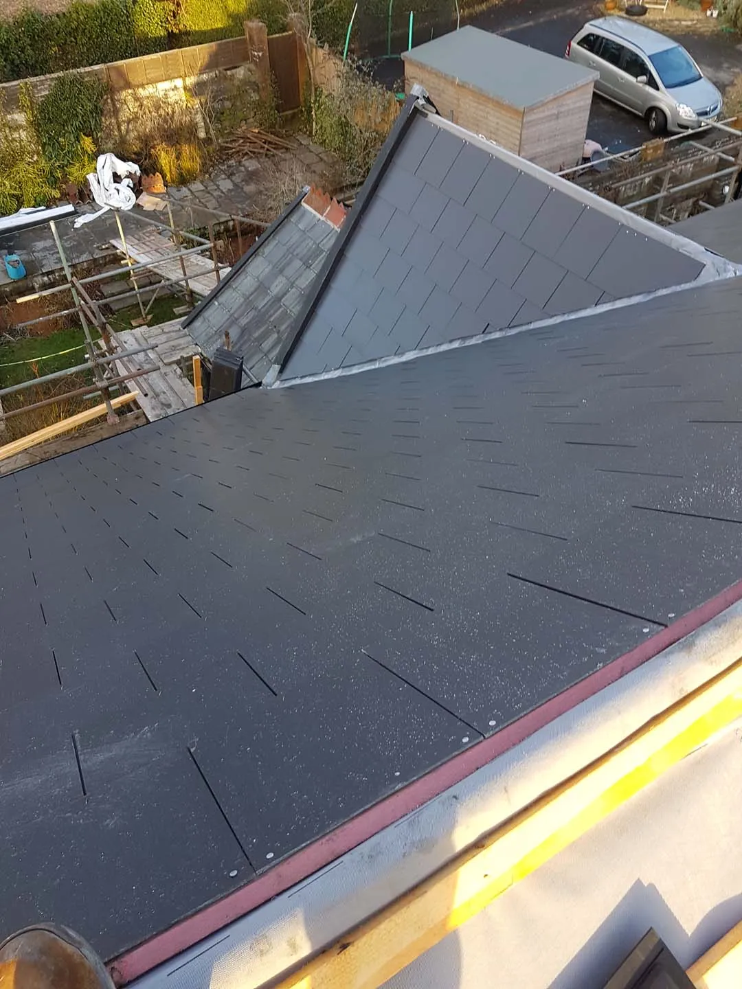 Finished slated roof with lead valleys around a gable dormer